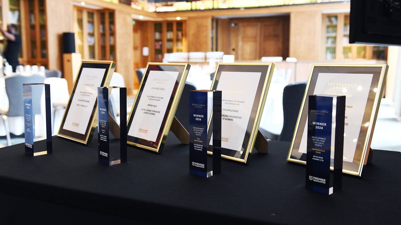 A table displaying several awards and framed certificates for excellence, set in a well-lit room.