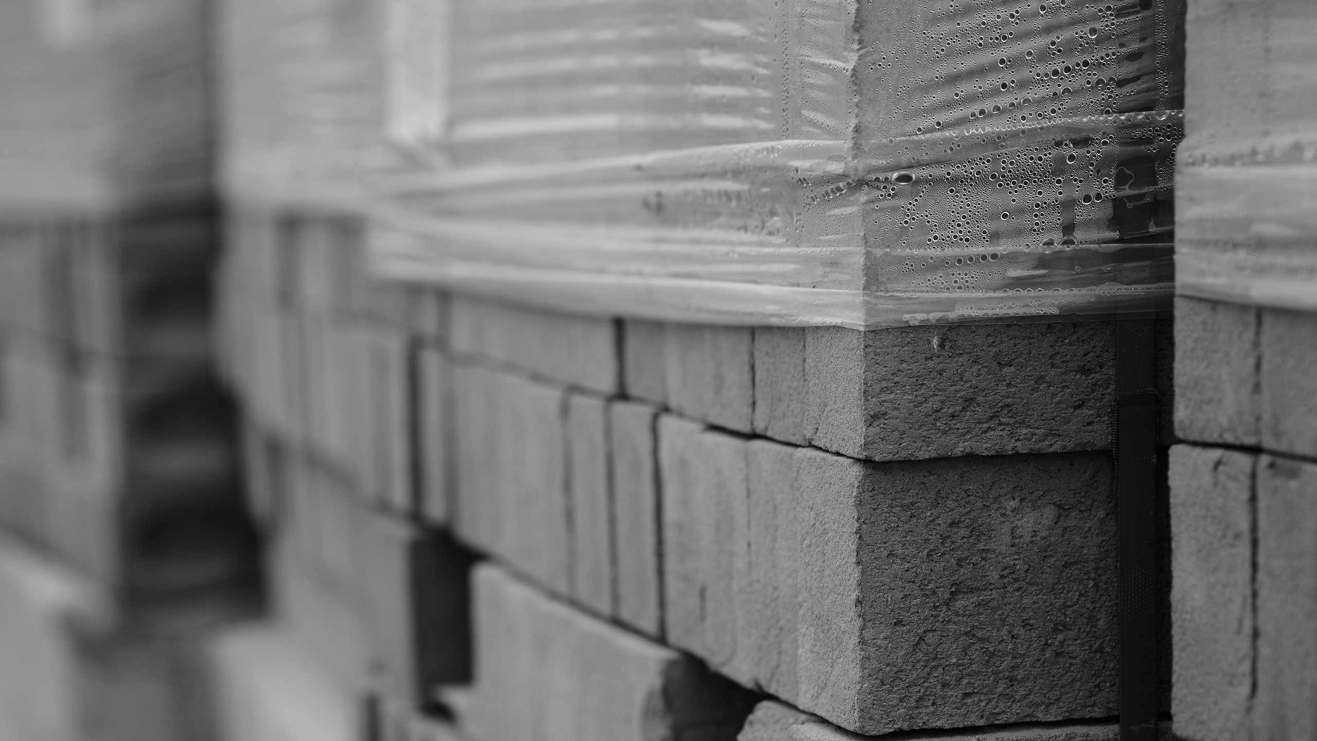 Housebuilders close up image of pile of bricks in black and white