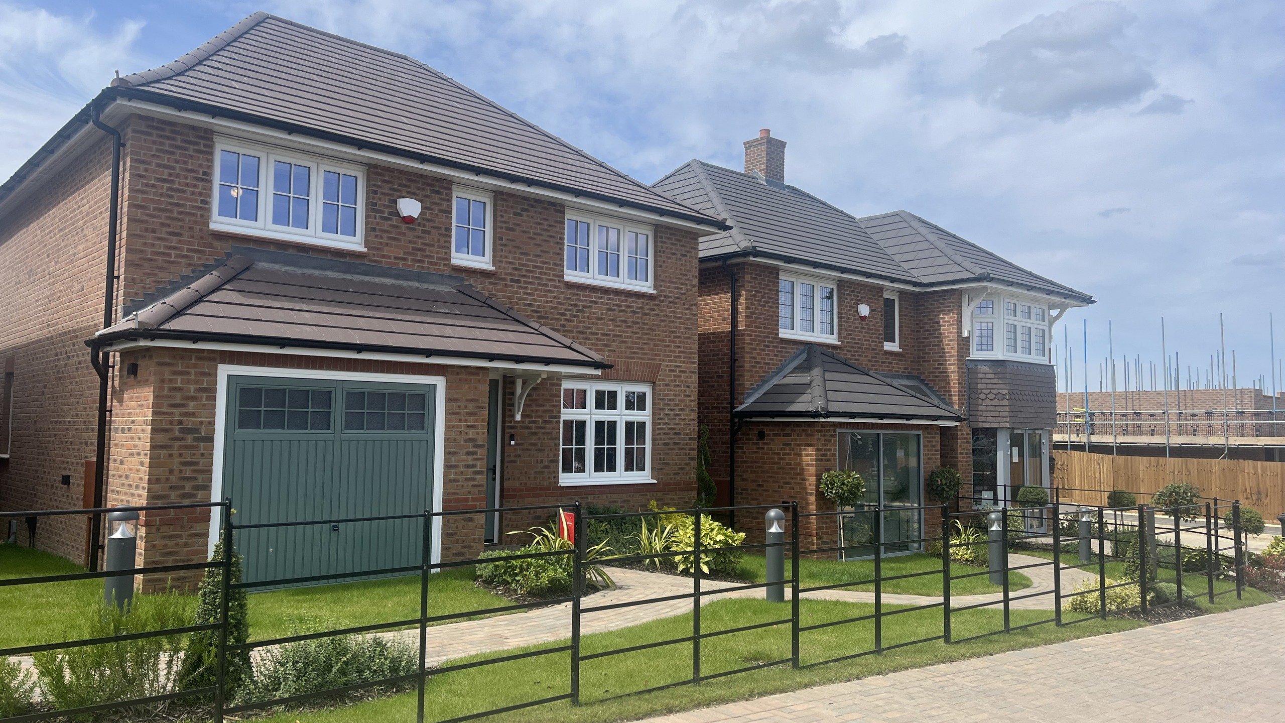 Image of two new build Redrow Homes on a sunny day.