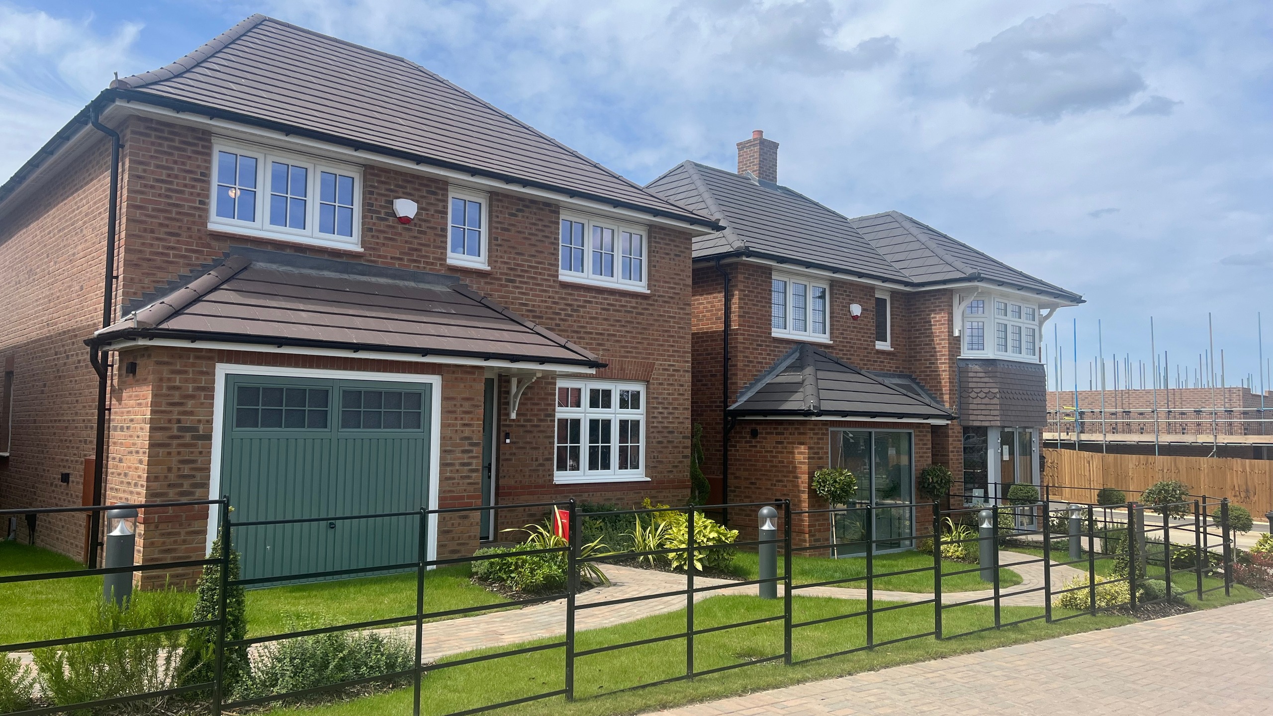 New Build Redrow Home on a sunny day with view of front garden