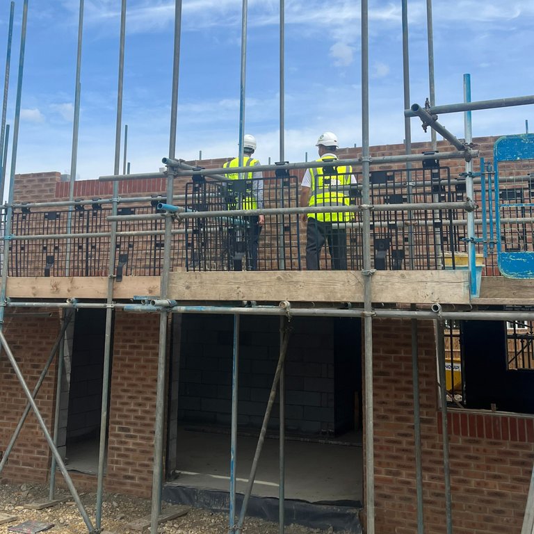Redrow Site in construction with Site Managers inspecting brickwork