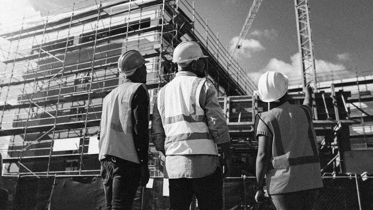 Warranty Inspectors and Site Managers looking up at building being contructed