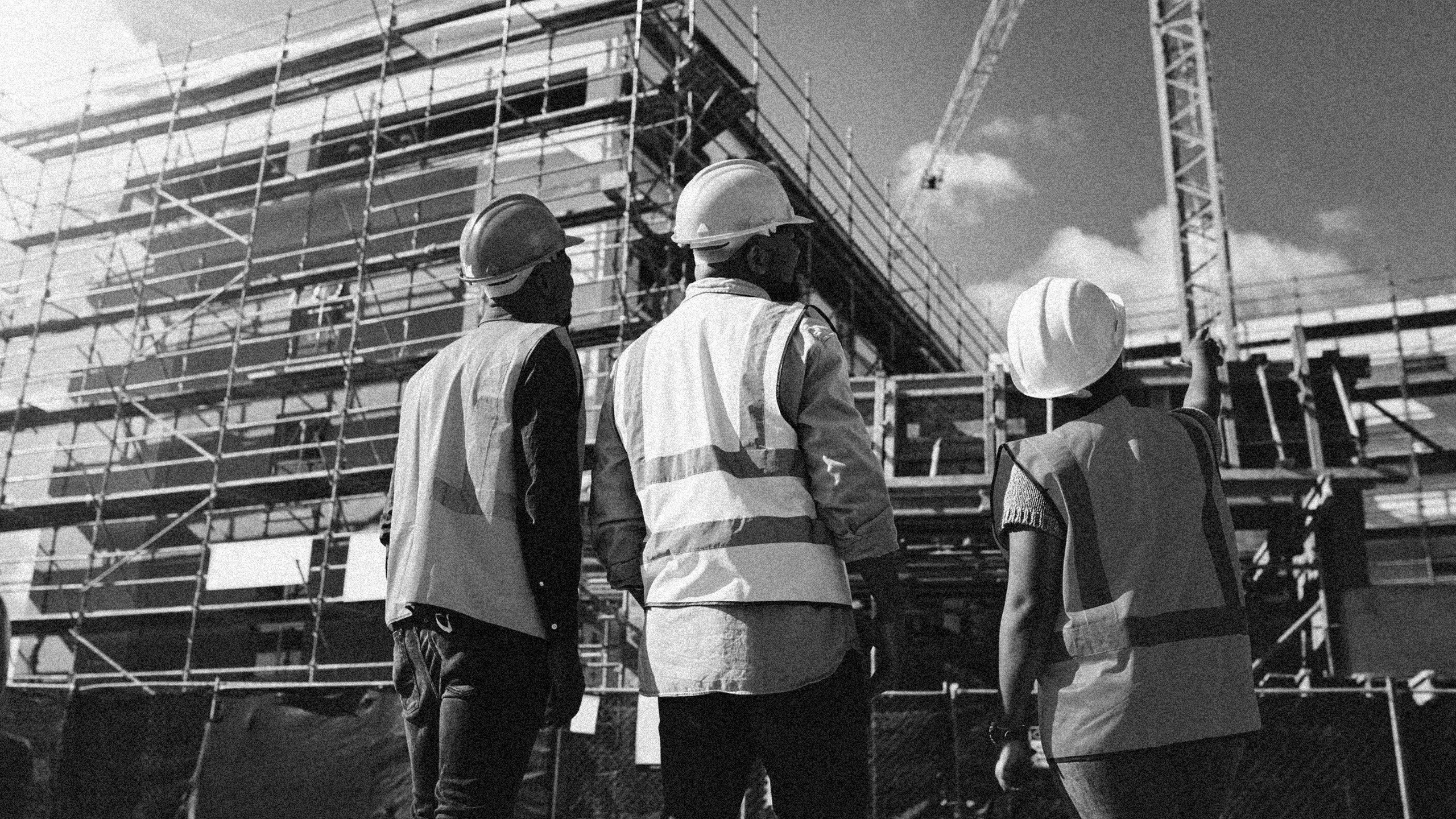 Warranty Inspectors and Site Managers looking up at building being contructed