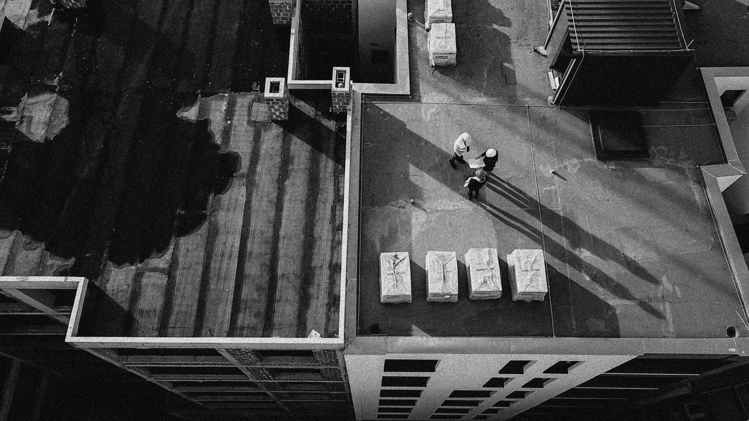 Aerial shot of construction workers on site - Black and white Aerial shot of construction workers on site - Black and white image