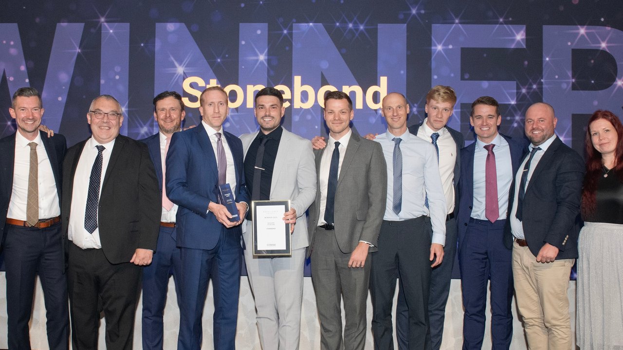 Female construction professional on the phone whilst inspecting a building site with safety gear