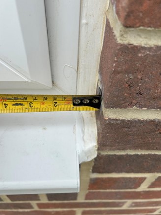 Measuring tape showing excessive sealant lines 