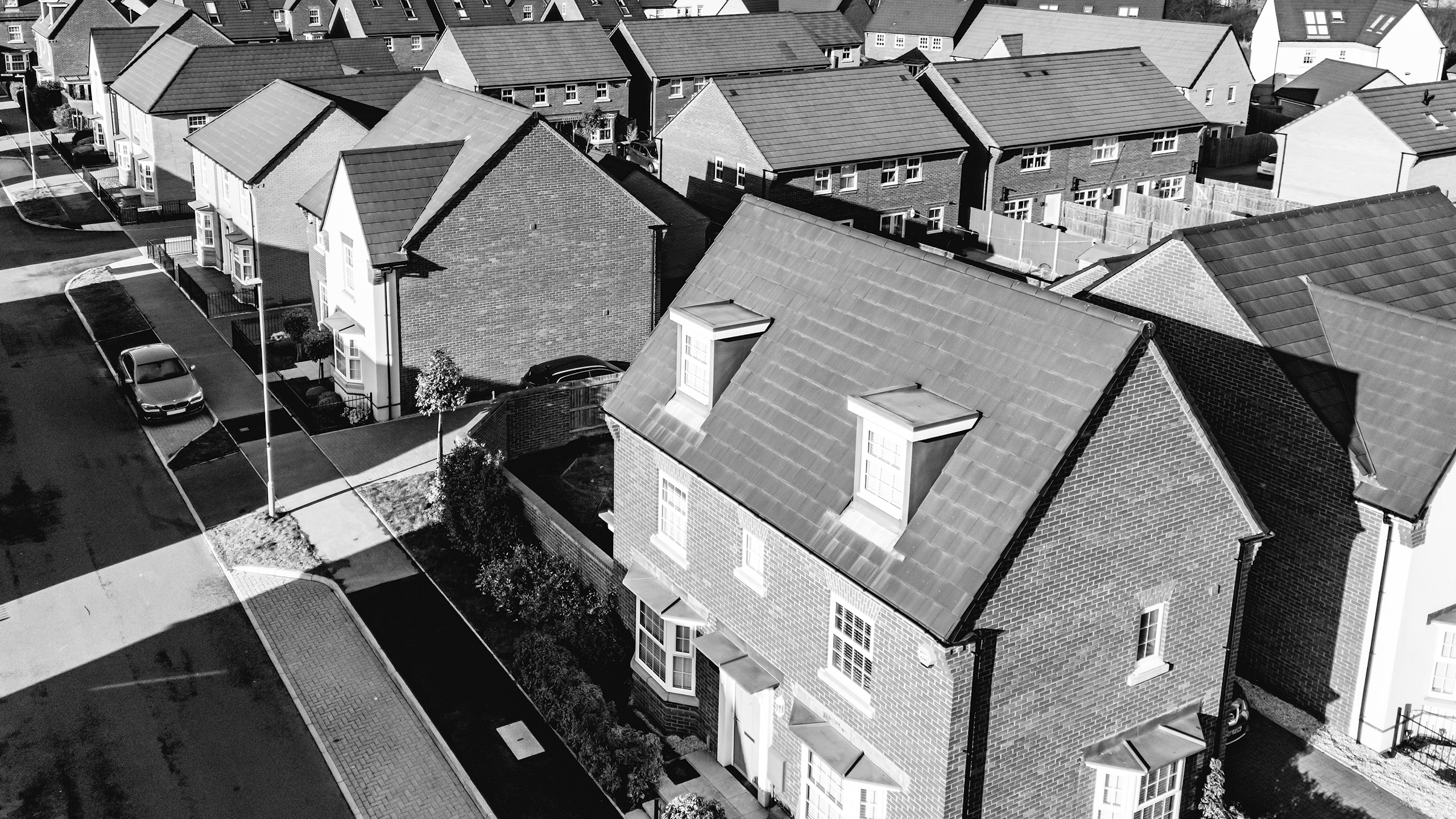 Risk Topics LVS Black and white image of aerial view of a new home site low value scheme