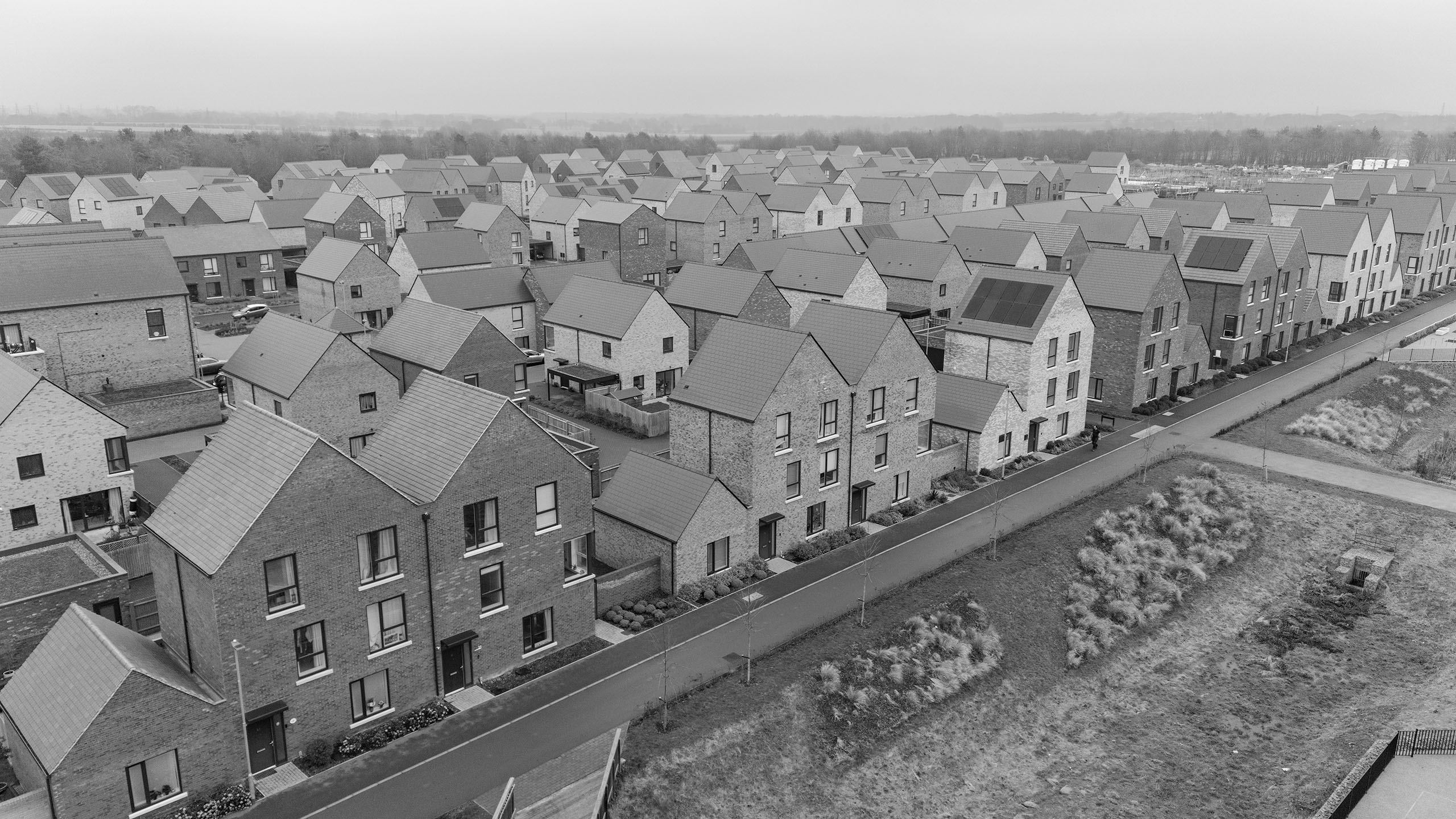 Risk Topics MVS Black and white image of aerial view of a new home site medium value scheme
